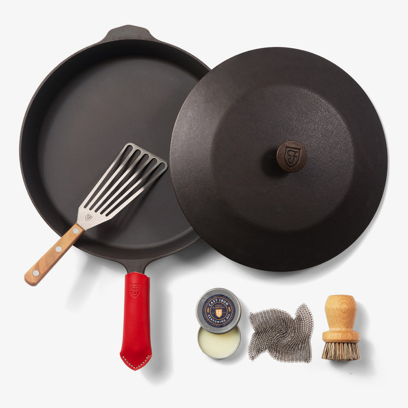 Overhead of the Chef's Starter Set No.12: Field Skillet with lid, slotted turner, red handle cover, and care tools