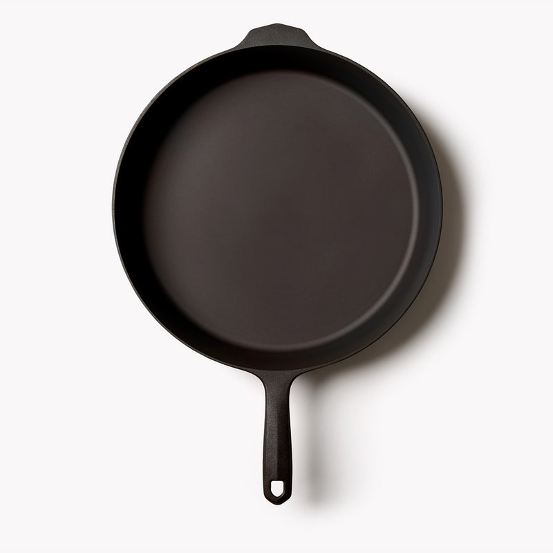 Overhead view of the No.12 Field Cast Iron Skillet on a white background, helper handle at top