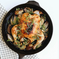 Whole roast chicken with herbs and shallots in the No.10 Field Cast Iron Skillet, overhead view thumbnail