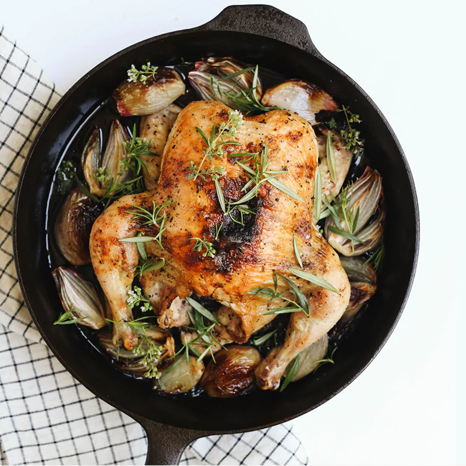 Whole roast chicken with herbs and shallots in the No.10 Field Cast Iron Skillet, overhead view