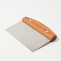 Angled view of the Field Bench Scraper with cherry wood handle and stainless steel blade thumbnail