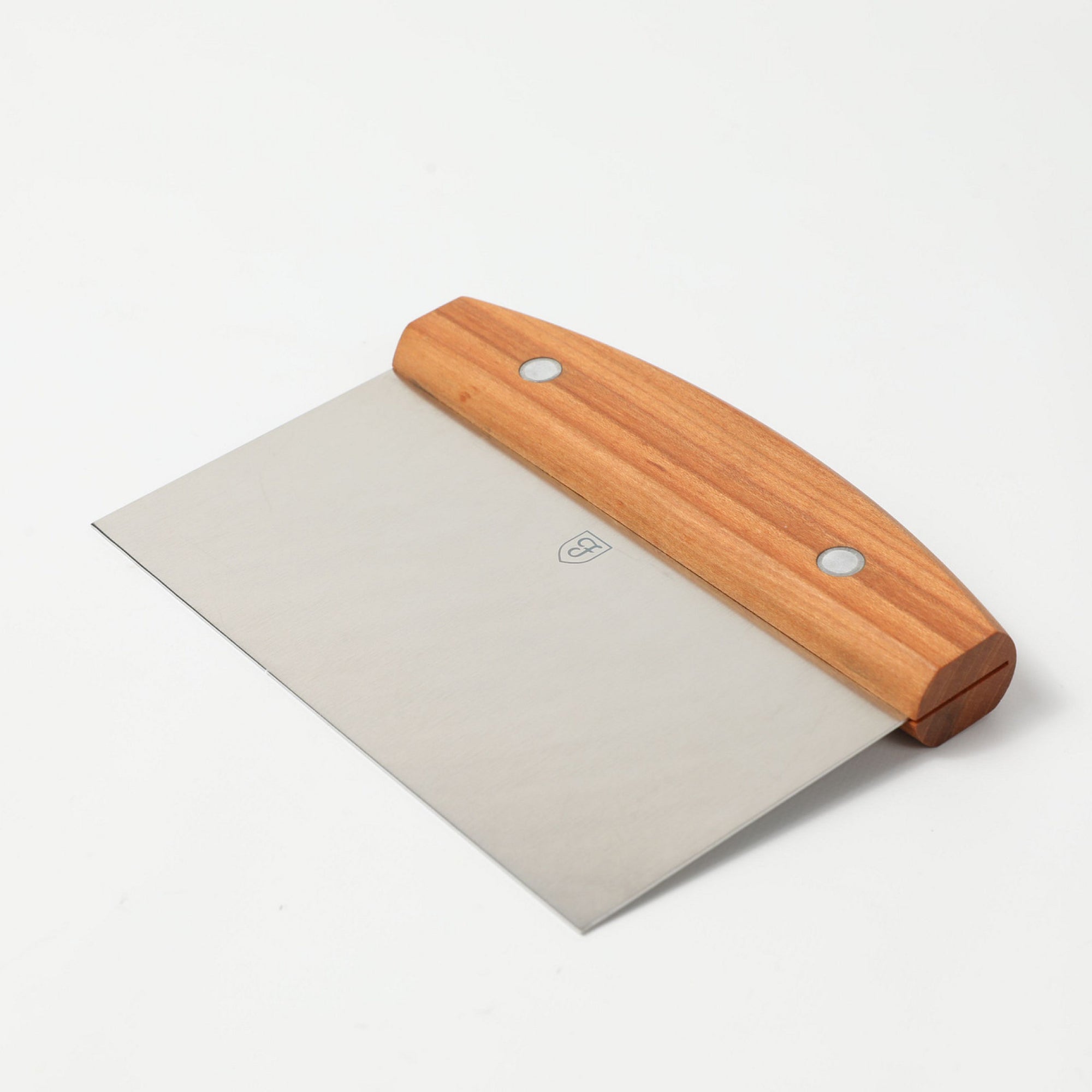 Angled view of the Field Bench Scraper with cherry wood handle and stainless steel blade