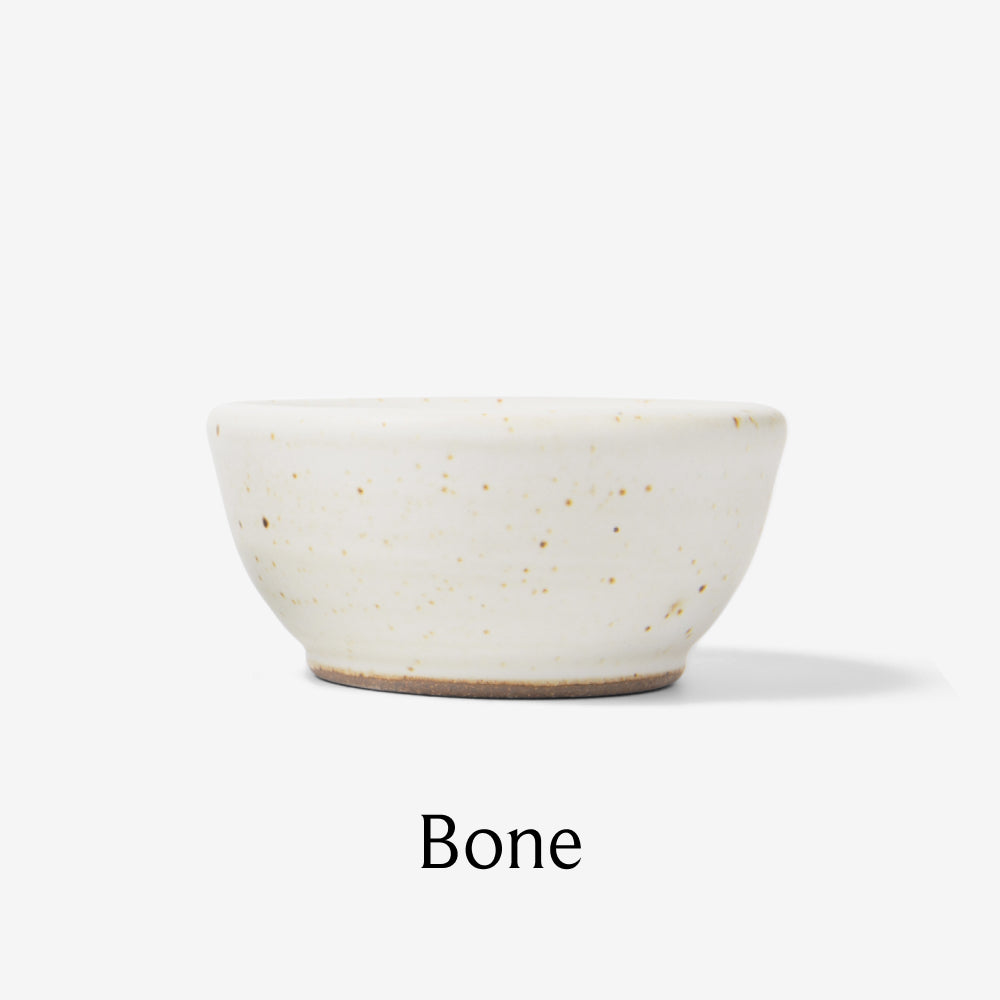Side view of the Tiny Ceramic Bowl from Field Company in speckled bone glaze