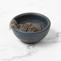 Tiny Field ceramic bowl in slate blue holding a chain mail scrubber, on a marble counter thumbnail