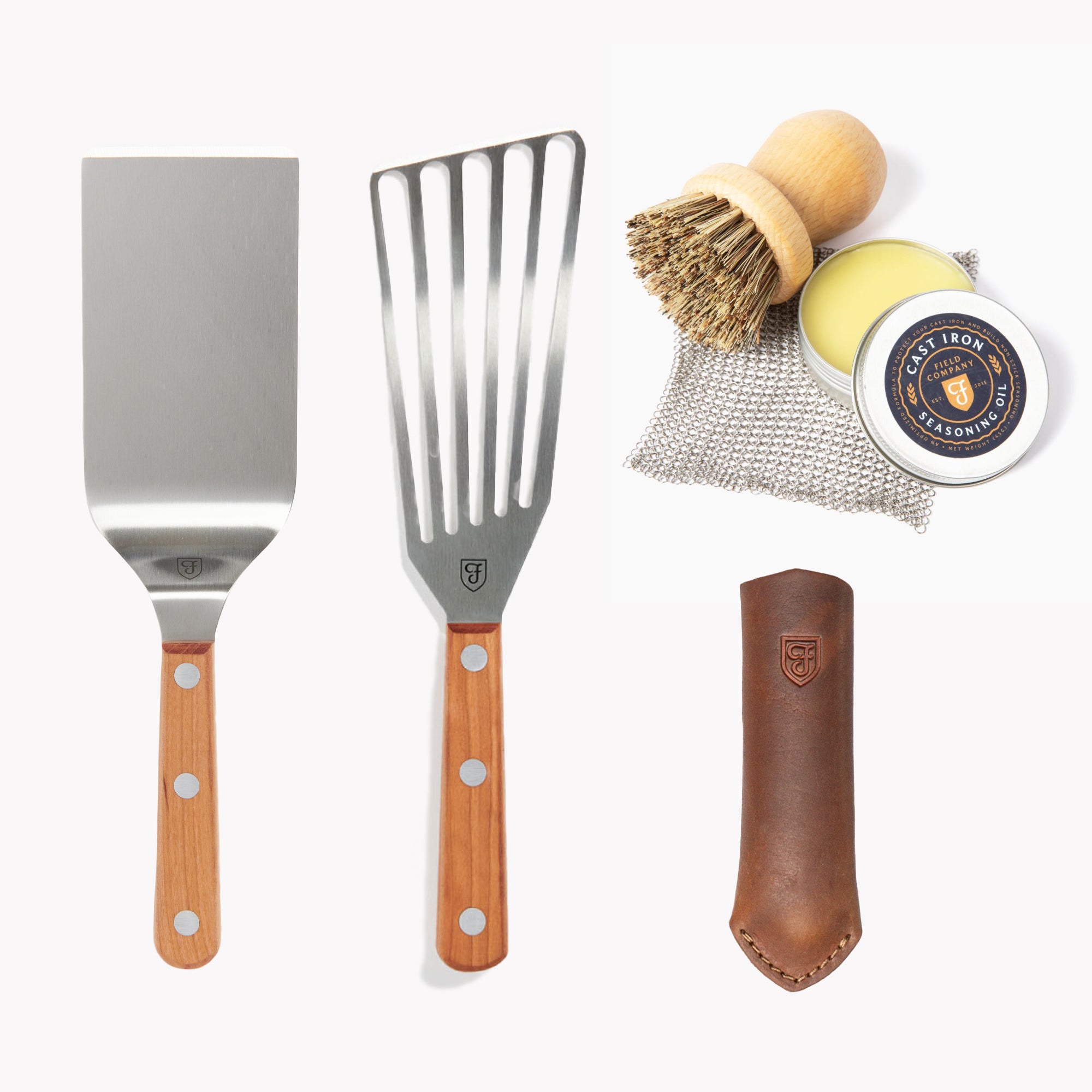 Field Cast Iron Tools Set laid out: two turners, scrub brush, chain mail, seasoning oil, and leather handle cover