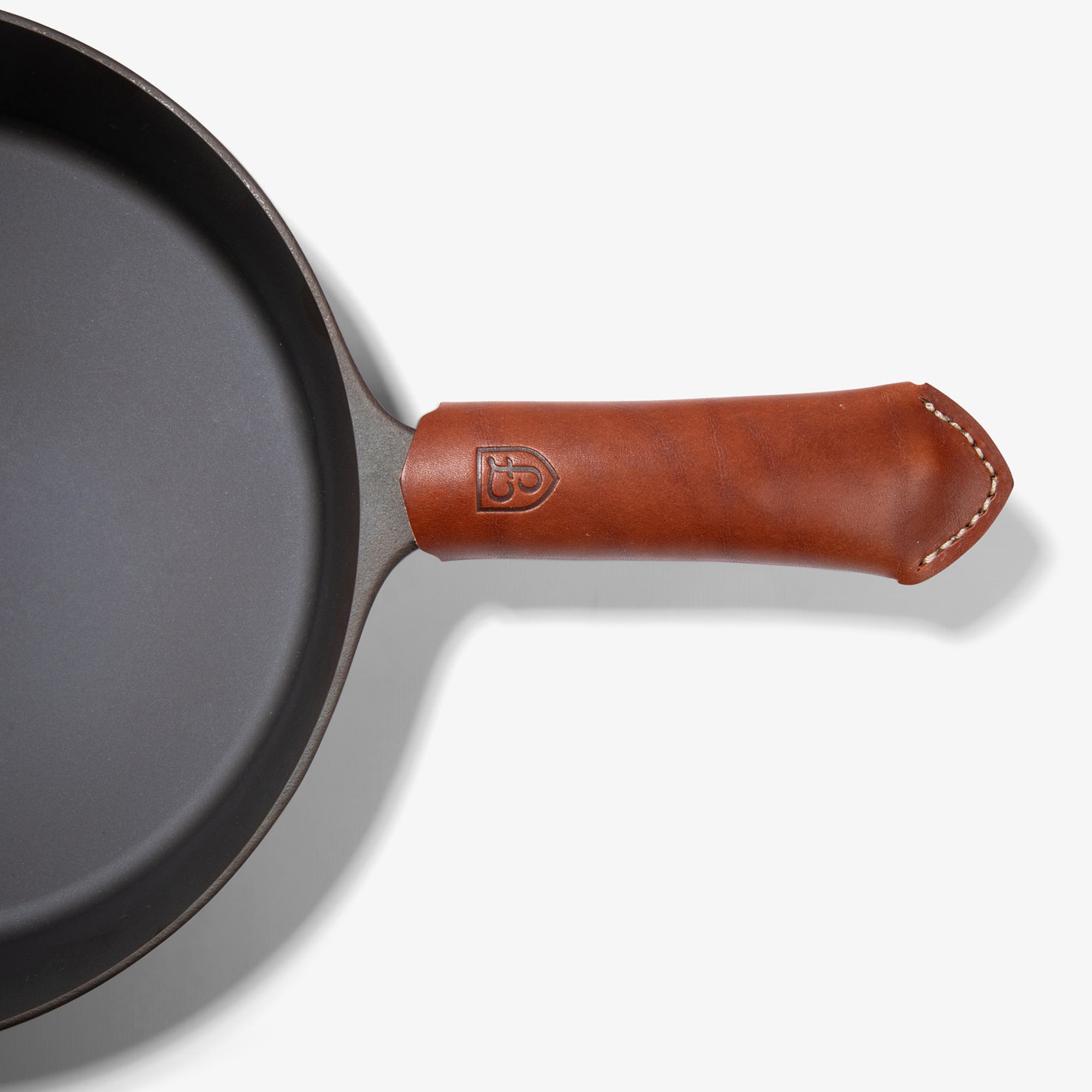 Brown Field Leather Handle Cover with white stitching on the handle of the Field Skillet, seen from above