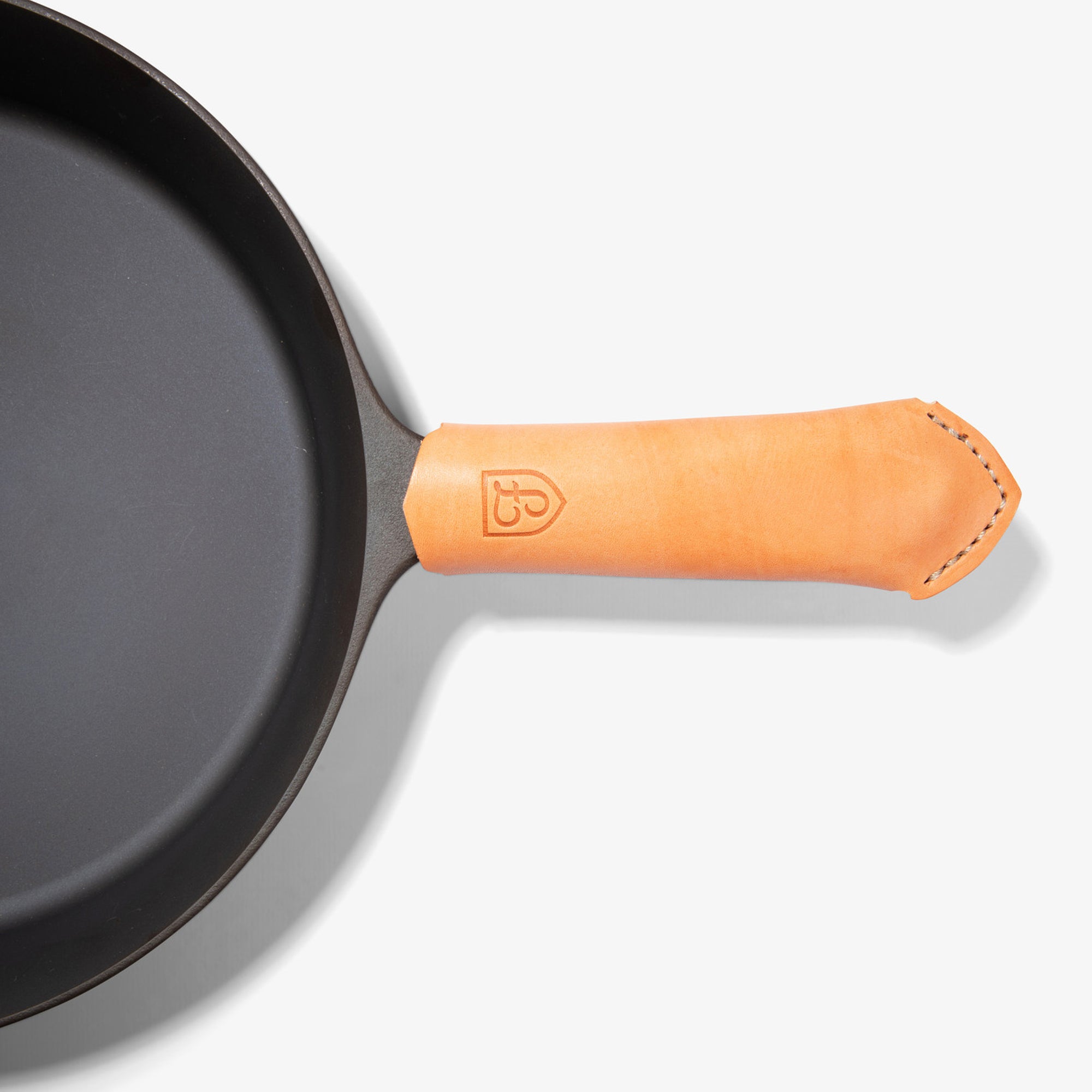 Tan Field Leather Handle Cover with stitched tip on the handle of the Field Skillet, seen from above