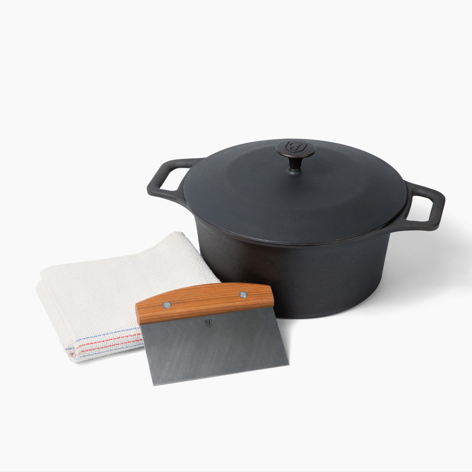 The No.8 Bread Baking Set: Field Dutch Oven with lid, bench scraper, and baking cloth, studio shot