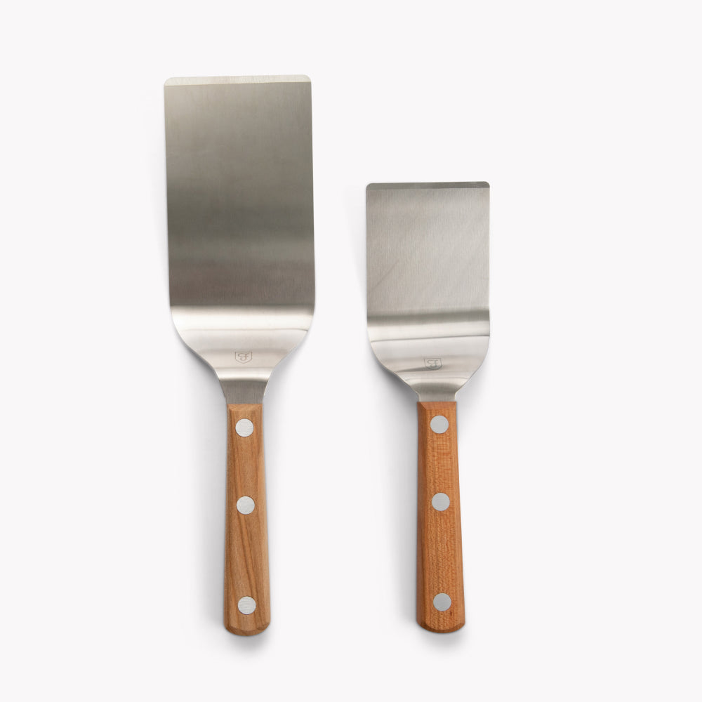 The Turner Duo: Field Griddle Turner and Mini Turner side by side with cherry wood handles