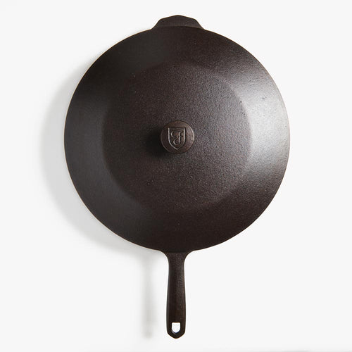 Overhead view of a Field Skillet topped with its cast iron lid and shield-stamped knob