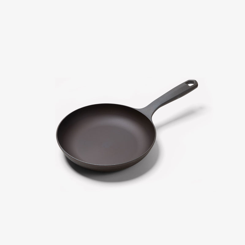 Angled view of the No.5 Field Cast Iron Chef Skillet with sloped sides and long handle with hanging hole