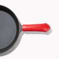 Overhead detail of the red Field Leather Handle Cover on a skillet handle, contrast stitching at the tip thumbnail