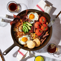 Skillet breakfast of fried eggs, bacon, avocado, and tomatoes in the No.12 Field Cast Iron Skillet thumbnail
