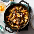 Baked rigatoni in the No.8 Field Cast Iron Dutch Oven with a wooden spoon, overhead view thumbnail
