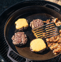 Cheeseburgers and steak cooking on the No.16 Double-Handled Field Skillet over a kettle grill thumbnail