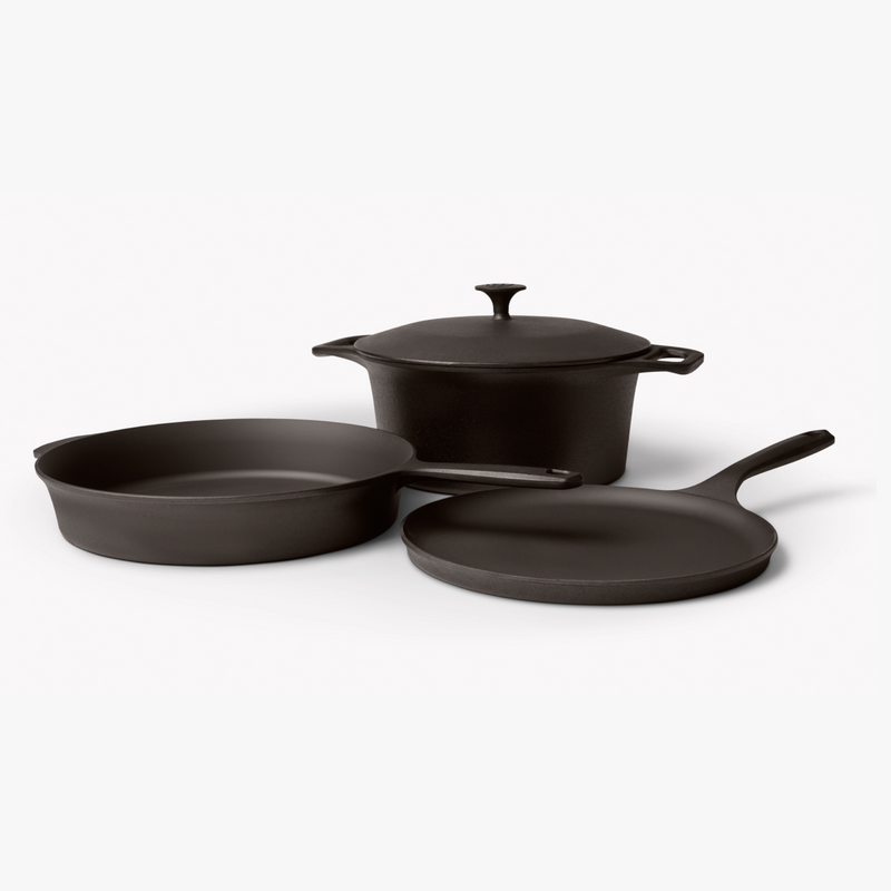 Angled view of the 4-Piece Field Cast Iron Cookware Set: lidded Dutch oven, skillet, and round griddle