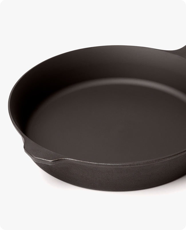 Angled close-up of the Field Skillet rim showing its machined-smooth cooking surface