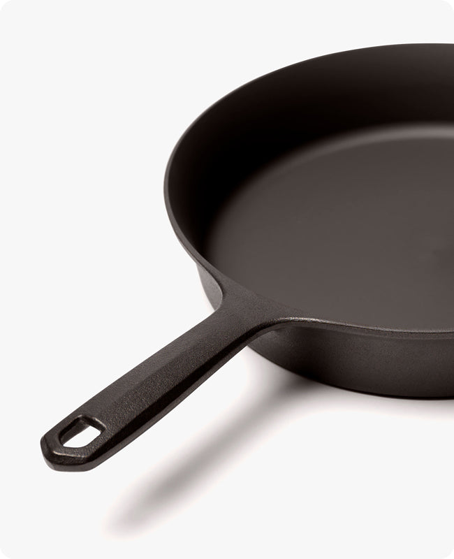 Angled close-up of the Field Skillet with its handle and hanging hole in the foreground