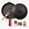Overhead of the Chef's Starter Set No.12: Field Skillet with lid, slotted turner, red handle cover, and care tools thumbnail