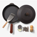 Overhead of the Chef's Starter Set No.10: Field Skillet with lid, slotted turner, leather handle cover, and care tools thumbnail