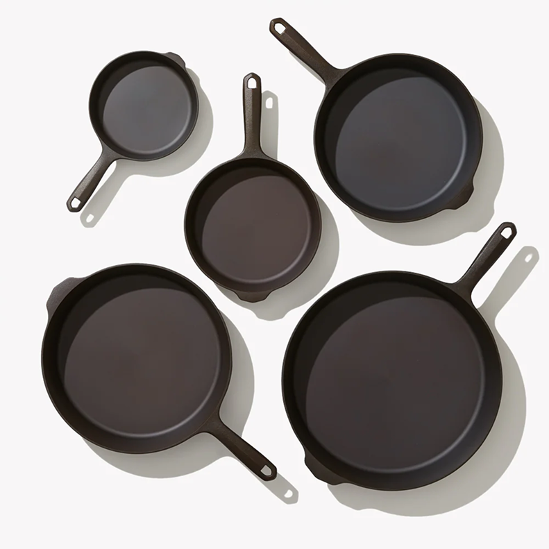 Overhead view of the five cast iron skillets and griddles in the Field Hosting Set