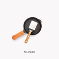 Field Mini Turner resting in a No.4 Skillet with tan leather handle cover, overhead view thumbnail