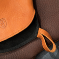Detail of a Field Leather Oven Mitt showing the stitched hanging loop and tan grain thumbnail