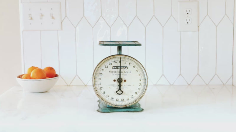 Video of a hand placing a Field Skillet on an antique kitchen scale