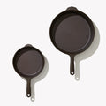 Overhead view of the two Field Skillets in the 2-Piece Cookware Set, helper handles at top thumbnail