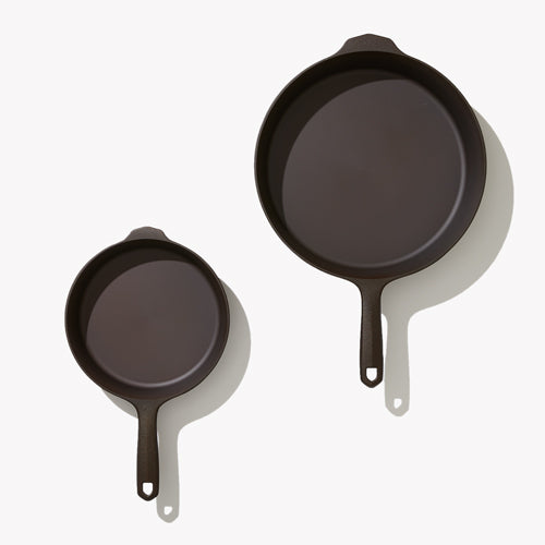 Overhead view of the two Field Skillets in the 2-Piece Cookware Set, helper handles at top