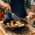 Person flips seared scallops with a Field slotted turner over the DIY Konro grill outdoors thumbnail
