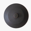 Top-down detail of the Field cast iron lid with shield-stamped knob at center thumbnail