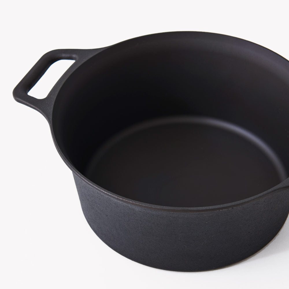 Angled close-up of the Field Cast Iron Dutch Oven interior showing its depth and loop handle