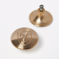 Two Bronze Knobs for the Field Lid, one showing the engraved shield logo and one flipped to show the mounting screw thumbnail