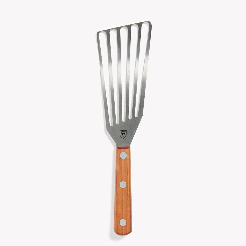 Right-handed Field Slotted Turner with slotted stainless blade and riveted wood handle on a white background