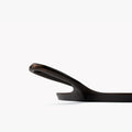 Side profile close-up of the Field Round Griddle's upswept handle and hanging hole thumbnail
